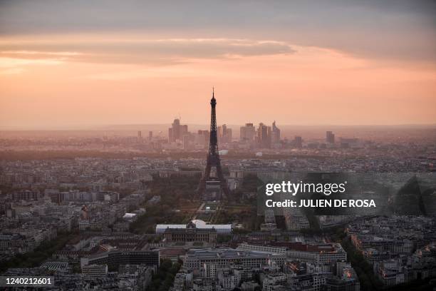 This photograph shows the sun sets on the Eiffel Tower and the Champ de Mars in Paris, on April 24 after French President and La Republique en Marche...