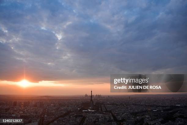 This photograph shows the sun sets on the Eiffel Tower in Paris, on April 24 after French President and La Republique en Marche party candidate for...