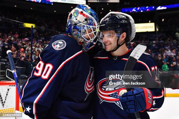 Elvis Merzlikins celebrates with Nick Blankenburg of the Columbus Blue Jackets after a 5-2 win over the Edmonton Oilers at Nationwide Arena on April...