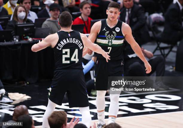 Milwaukee Bucks guard Pat Connaughton and Milwaukee Bucks guard Grayson Allen react to a play during Game Four of the Eastern Conference First Round...