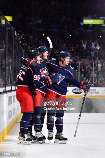 Jack Roslovic of the Columbus Blue Jackets celebrates his third period goal with teammates Andrew Peeke and Jake Bean of the Columbus Blue Jackets...