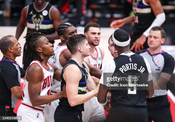 Milwaukee Bucks center Bobby Portis and Chicago Bulls guard Zach LaVine have to be pushed back by teammates after a foul during Game Four of the...