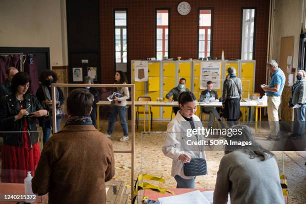 Voters seen at the polling station in Paris during the French election day. Election day in France to choose the president of the government between...