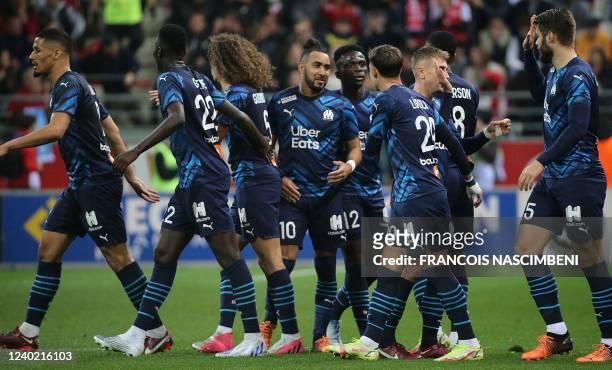 Marseille's players celebrate after scoring during the French L1 football match between Stade de Reims and Olympique de Marseille at Stade...