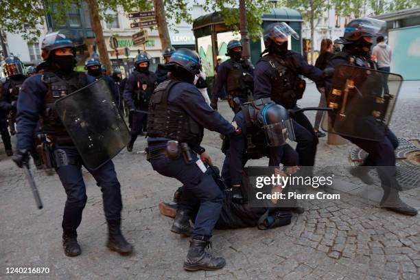 Police arrest a man during a protest of centrist incumbent President Emmanuel Macron's apparent defeat of far-right rival Marine Le Pen for a second...