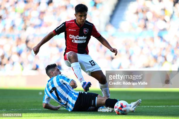 Gabriel Hauche of Racing Club competes for the ball with Juan Sforza of Newell´s Old Boys during a match between Racing Club and Newell's Old Boys as...