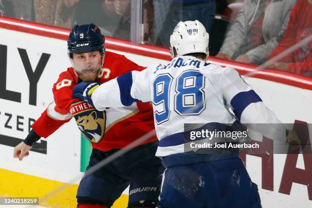 Mikhail Sergachev of the Tampa Bay Lightning and Sam Bennett of the Florida Panthers fight during second period action at the FLA Live Arena on April...