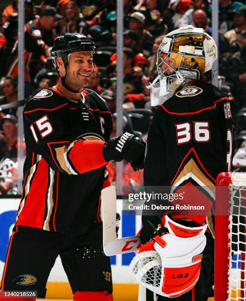 Ryan Getzlaf of the Anaheim Ducks and John Gibson high five during the second period against the St. Louis Blues at Honda Center on April 24, 2022 in...