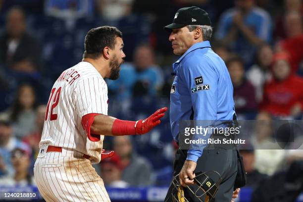 Kyle Schwarber of the Philadelphia Phillies argues with home plate umpire Angel Hernandez after being called out on strikes during the ninth inning...