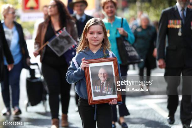 April 25: A participant holds a photo of a family member during the ANZAC Day March in Sydney, on Sunday, April 25, 2022.