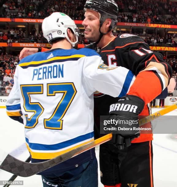 Ryan Getzlaf of the Anaheim Ducks celebrates his last career NHL game with David Perron of the St. Louis Blues after the game at Honda Center on...