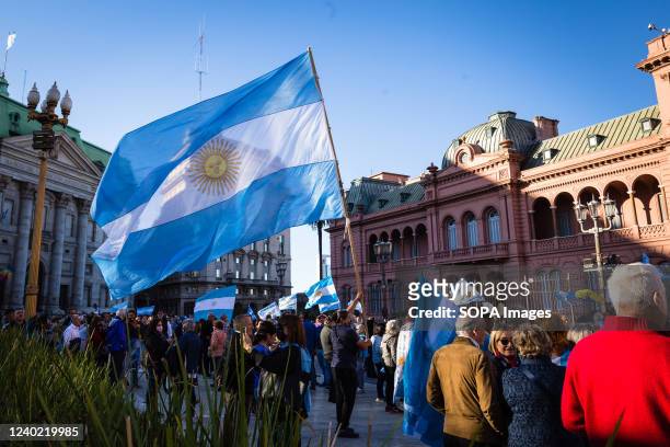 Demonstrator is seen holding an Argentine flag at the entrance to the Casa Rosada, seat of political power of Argentine President Alberto Fernadez...