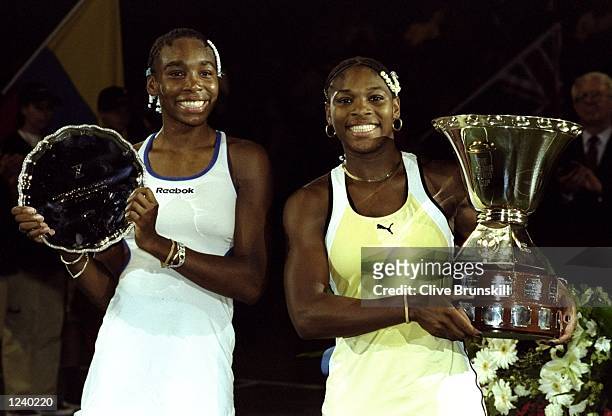 Venus and Serena Williams of the USA show off their respective trophies at the Grand Slam Cup from the Olympiahalle, Munich, Germany. \ Mandatory...