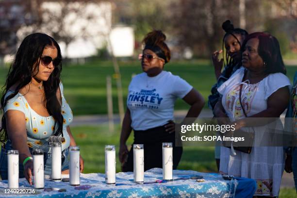 Hana Abdur-Rahim, a Columbus organizer for Black Abolitionist Collective of Ohio, lights candles at a Community Vigil for MaâKhia Bryant one year...