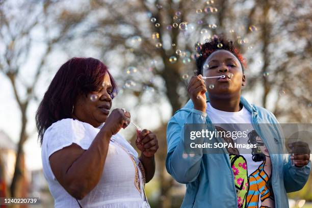 Jeanene Hammonds, MaâKhia Bryantâs grandmother, and Azariah Bryant MaâKhia Bryantâs sister, blow bubbles at a Community Vigil for MaâKhia...