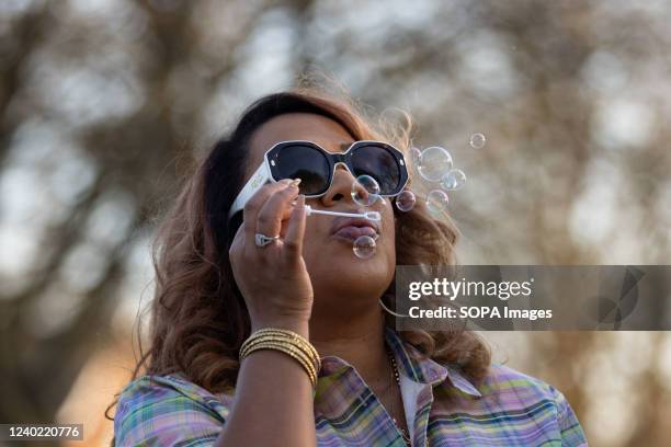 Myra Duke, MaâKhia Bryantâs aunt, blows bubbles at a Community Vigil for MaâKhia Bryant. A candlelight vigil and memorial was held for...