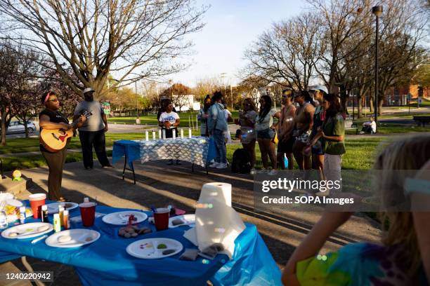 Paisha Thomas, a musical artist, sings and plays original songs on guitar at the Community Vigil of MaâKhia Bryant marking one year since MaâKhia...