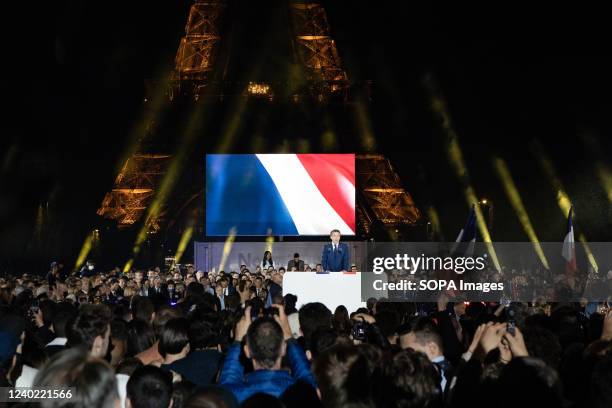French President Emmanuel Macron won the second term on Sunday, as he celebrates with thousands of his supporters in front of the Eiffel Tower in...