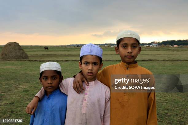 Three madrasa students pose for a photo.