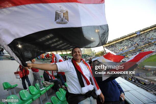 Supporters of Egypt hold their country's flag as they cheer in the stands before the Fifa Confederations Cup football match Brazil vs Egypt on June...