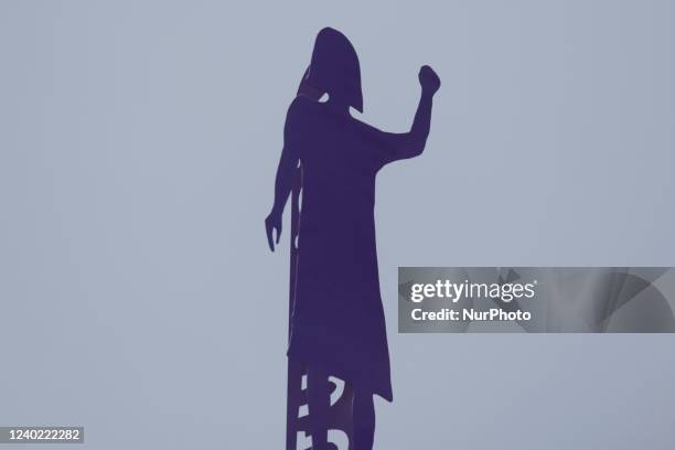 Silhouette of a woman on the Glorieta de las Mujeres que Luchan as feminist collectives demonstrate in Mexico City, demanding justice and punishment...