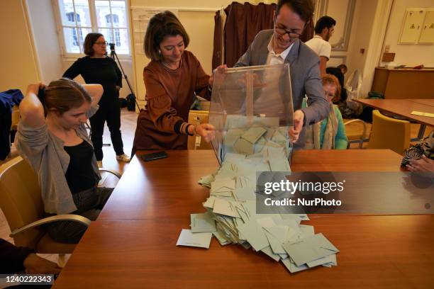 Assessor and president of the polling station empty the urn with ballot box before counting. Counting the ballot papers in a Toulouse's polling...