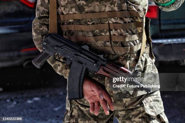 An armed serviceman is on duty during a response effort at an apartment block damaged by a Russian missile strike in Odesa, southern Ukraine. The...