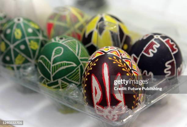 The tryzub , the main element of Ukraine's minor coat of arms, is painted on an eggshell during a masterclass on making pysankas held for the...