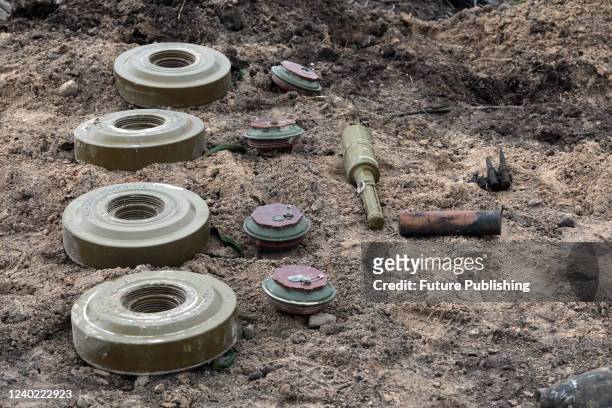 Ammunition is arranged on the ground during a mine clearance mission near Bervytsia, a village liberated from Russian occupiers, Kyiv Region,...
