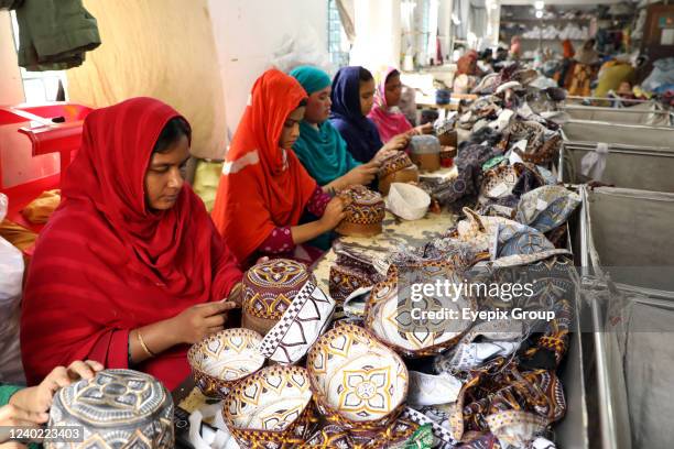 Employees are seen work during the production of hats inside a factory ahead of Eid-ul-Fitr at a factory in Dhaka, Bangladesh, April 23, 2022. On...