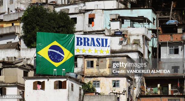 Brazilian flag hangs in a favela of Rio de Janeiro ahead of the FIFA 2010 World Cup in South Africa, on June 3, 2010. AFP PHOTO/VANDERLEI ALMEIDA