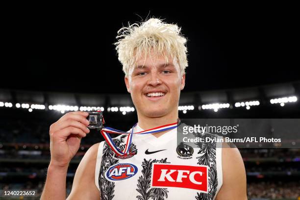 Jack Ginnivan of the Magpies poses for a photo with the Anzac Day medal during the 2022 AFL Round 06 match between the Essendon Bombers and the...