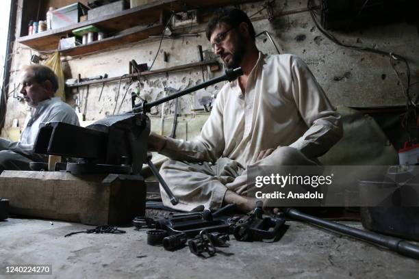 Pakistani man manufactures a weapon at his gun shop in Darra Adam Khel village, in Peshawar, Pakistan on April 20, 2022. The Pakistani city of Darra...