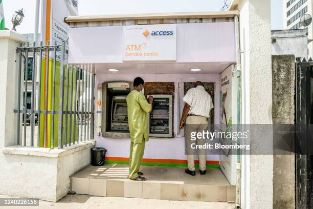 Customers use automatic teller machines outside an Access Bank Plc bank branch in Lagos, Nigeria, on Friday, April 22, 2022. Choked supply chains,...