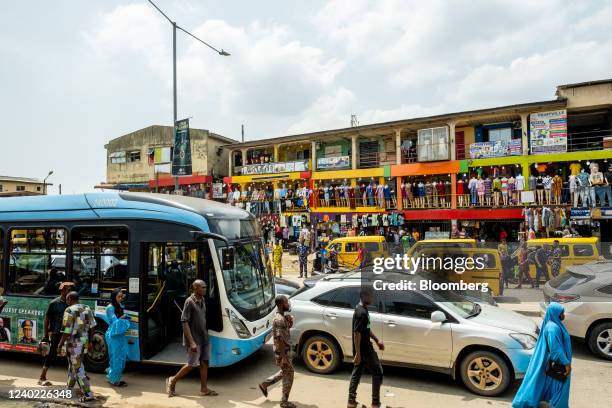 Vehicles in heavy traffic pass clothing stores by Ikeja Underbridge in Lagos, Nigeria, on Friday, April 22, 2022. Choked supply chains, partly due to...