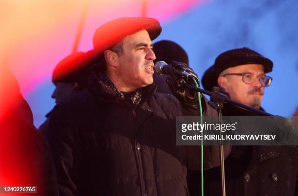 Former chess champion turned Kremlin critic Garry Kasparov speaks as the activist and counterculture writer Eduard Limonov listens during a rally of...