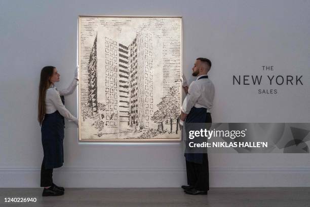 Members of staff hang a painting made in 1967 by Danish artist Sigmar Polke, called "Hauserfront" which is estimated between $10 000 and 15 000,...