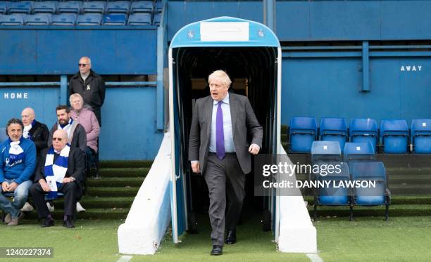 Britain's Prime Minister Boris Johnson arrives on the pitch during a visit to the football club Bury FC at their ground in Gigg Lane, Bury, Greater...
