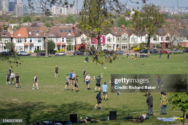 Local game of touch rugby is played in Ruskin Park, a south London green space that overlooks houses in Lambeth, on 24th April 2022, in London,...