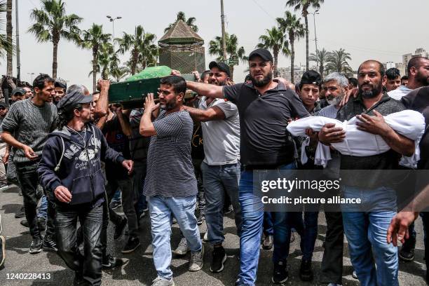 April 2022, Lebanon, Tripoli: Mourners carry the bodies of four-year-old Taline al-Hamoui and her mother Rihab who were killed after a boat loaded...