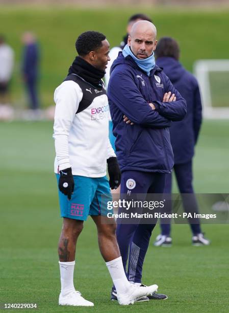 Manchester City's Raheem Sterling with manager Pep Guardiola during a training session at the City Football Academy, Manchester. Picture date: Monday...