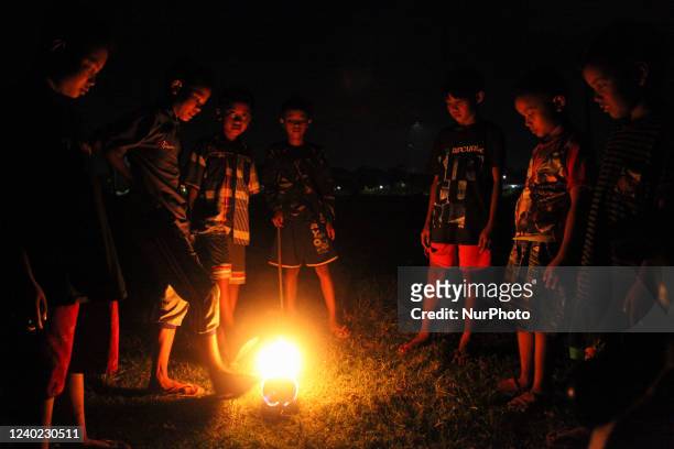 Children's play the traditional game of fire football in a field in Tubanan, Surabaya, East Java, on April 24, 2022. Local residents say this...