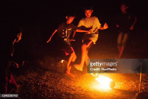 Children's play the traditional game of fire football in a field in Tubanan, Surabaya, East Java, on April 24, 2022. Local residents say this...