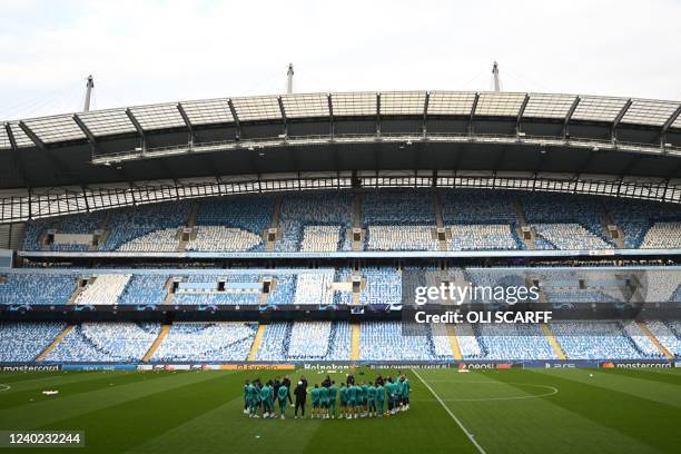 Madrid players have a talk ahead of a team training session at the Etihad Stadium in Manchester, north west England, on April 25 on the eve of their...