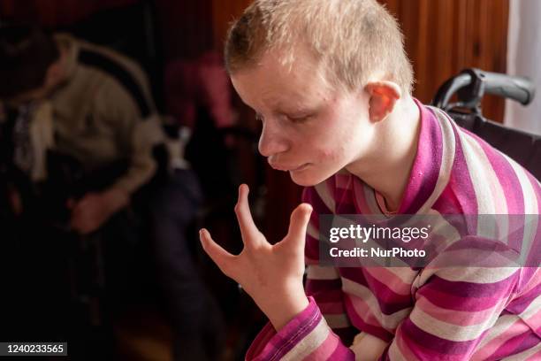 Ukrainian girl with learning and other disabilities sits in her armchair as she rests in a common room in a Center for women and girls with learning...