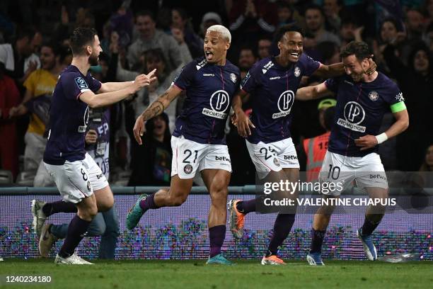 Toulouse's Belgian midfielder Brecht Dejaegere celebrates with Toulouse's Toulouse's Dutch midfielder Branco van den Boomen, Toulouse's Brazilian...