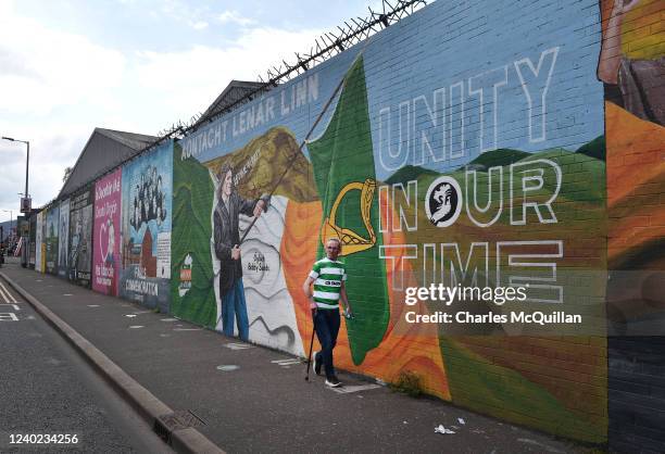 Man walks past a Sinn Féin mural calling for Irish unity on April 25, 2022 in Belfast, Northern Ireland. Sinn Fein could emerge from the May 5...