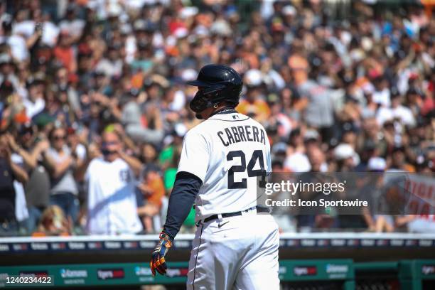 Fans stand and cheer in the background as Detroit Tigers designated hitter Miguel Cabrera walks to the dugout as he exits the game after Detroit...