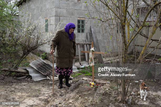 Hanna Chaika stands by the grave of her husband Petro Chaika, on April 25, 2022 in Ozera, Ukraine. Petro Chaika, born in 1939, died during the...