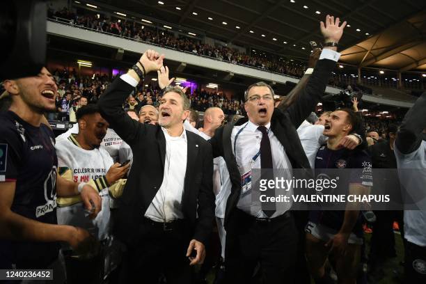 Toulouse's French coach Philippe Montanier and Toulouse's president Damien Comolli celebrate their victory and promotion back to Ligue 1 after the...